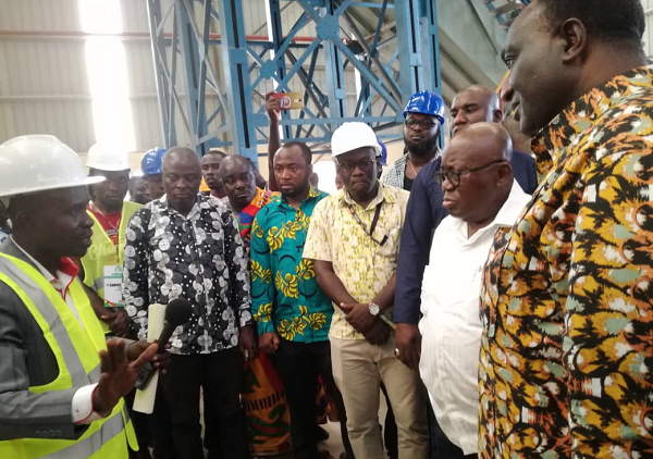 Mr Douglas Mensah (left), the Managing Director of the Komenda Sugar Factory, explaining a point to President Akufo-Addo and his team during a visit to the factory