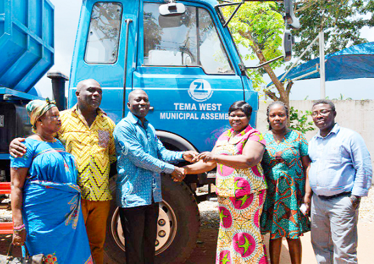 • Mr Ocran (middle) presenting the keys to the trucks to Mrs Adwoa Amoako (3rd right), MCE for Tema West.