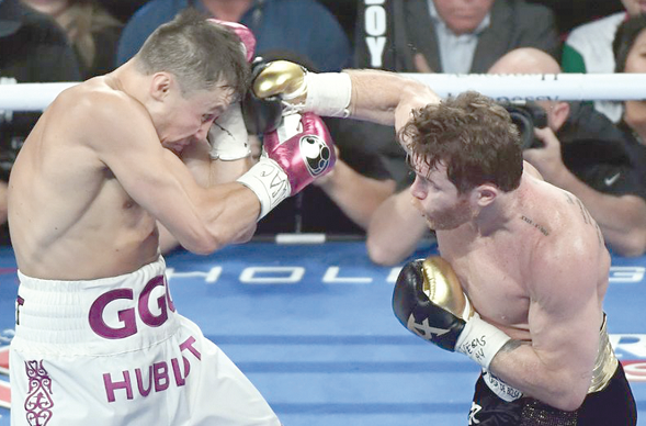 Camelo Alvarez(right) launches an attack against Gennady Golovkin