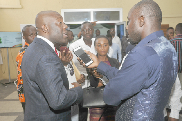 Mr Kojo Oppong Nkrumah (left), the Minister designate for Information, talking to some media personnel after the launch of the National Policy Summit 2018. Picture: EBOW HANSON