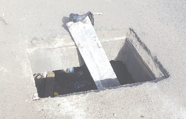Some sticks placed in the open drain to warn road users of danger