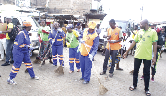 Some members of the group cleaning the Nima market