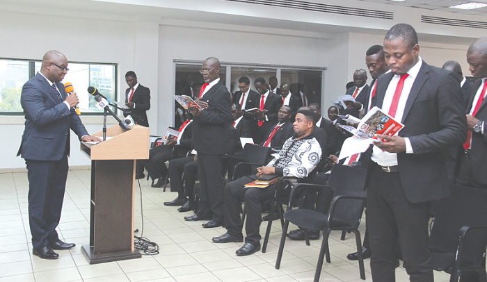 Justice Asare Nyarko (left), a High Court Judge, taking the new members through the induction process