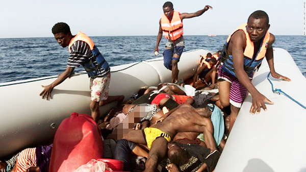  Some migrants stepping over dead bodies while being rescued in the Mediterranean Sea, off the coast 