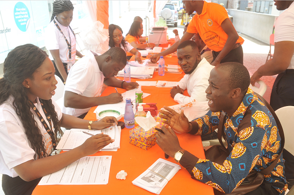 Some officials of SSNIT attending to some customers during the launch of the SSNIT Customer Service Mobile Clinic at the Oxford Street at Osu in Accra. Picture: EBOW HANSON 