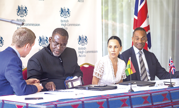 Mr Iain Walker (left) Bristish High Commissioner to Ghana interacting with Mr Kriston Akomeng Kissi, (2nd left), Board Chairman of the PMMC while Madam Baird and Mr Afriyie look on during the signing ceremony.