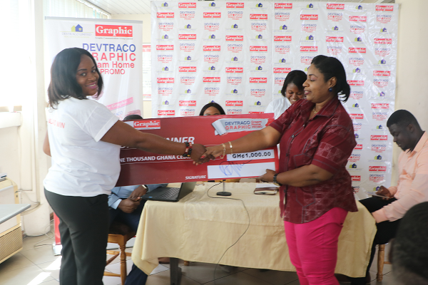 Rebecca Ekpe, winner receiving her cash prize