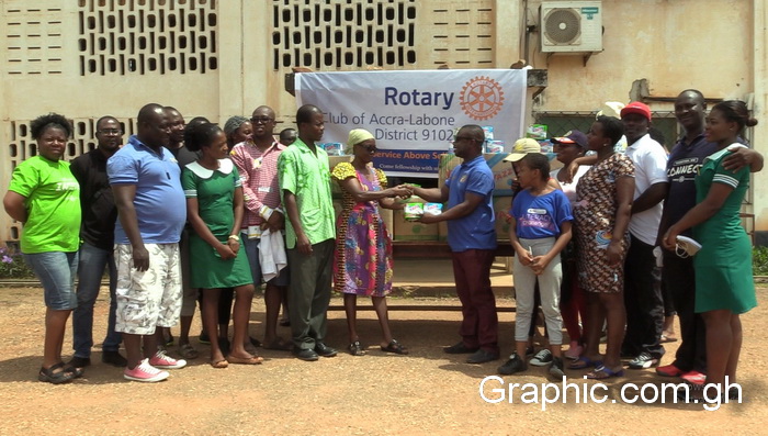 Yaw Korankye Abrokwa making a symbolic presentation of the sanitary towels to Madam Mary Kalawu Nurse Manager of the Hospital 