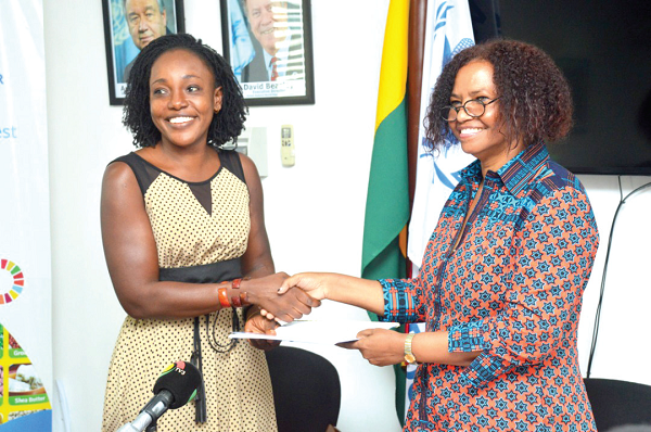  Ms Rukia Yacoub (right) exchanging a memorandum of understanding with ­Ms Alberta Akosa