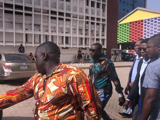 Salifu Maase aka Mugabe in green and black African wear at the court premises Wednesday morning