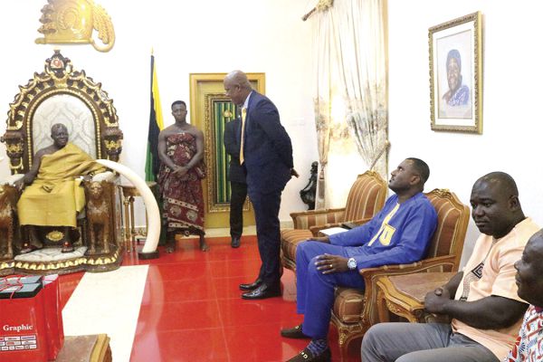  Mr Ato Afful (standing), addressing the Asantehene, during the courtesy call. Seated from right are Mr Frederick Akuamoah, Zonal Manager for Ashanti, Bono and the three Northern regions, and Director of Marketing, Mr Franklin Sowa