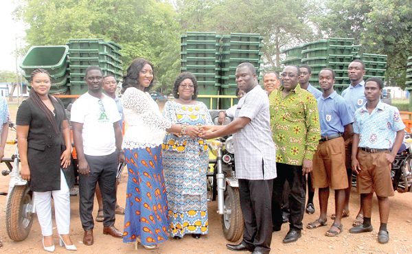  Dr Angela Tena Mensah (4th left) being assisted by Mrs Hannah Boahemaa Otu (3rd left), General Manager, Logistics Ghana Limited, to present the items to Mr David Odjidja (right), after the launch of the National Senior High School (SHS) Plastic Recovery Programme. Also in the photograph is Ms Adenyo (left), Public Relations Officer, Platinum Africa Solutions Limited teachers and students of PRESEC. Picture: Maxwell Ocloo