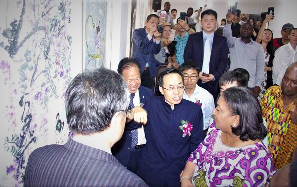 Mr Shi Ting Wang (3rd left), Ambassador of China to Ghana explaining the meaning of some paintings to the First Lady, Mrs Rebecca Akufo-Addo (right), at the exhibition. With them are some dignitaries. Picture: EDNA ADU-SERWAA