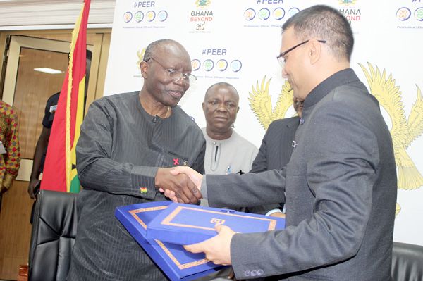 Mr Ken Ofori-Atta (left), the Minister of Finance, and Mr Pushpesh Tyagi (right), a representative of the Exim Bank, exchanging the signed document at a ceremony in Accra. Picture: GABRIEL AHIABOR