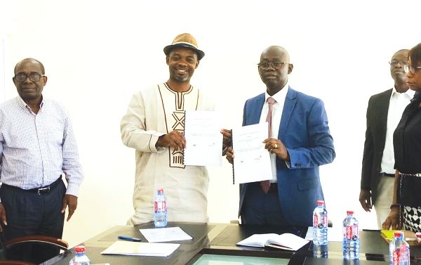 Chief Nat Nsarka (2nd left) and Professor Kwasi Opoku-Amankwa displaying the documents after signing the Memorandum of Understanding
