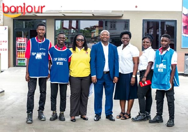 Mr Abdul-Rahim Siddique (Middle), Ms Millicent Nyarko, Network Training Manager of Total (3rd left), with some service staff