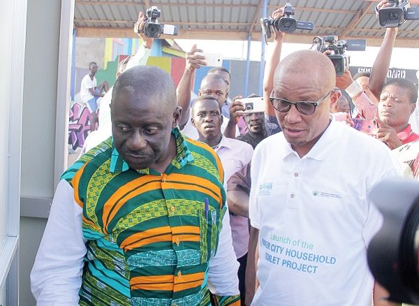 Mr Lukman Salifu (left), Contractor, Attachy Construction, briefing the Minister of Inner Cities and Zongo Development, Dr Mustapha Abdul-Hamid, on the toilet facility (inset). Picture: Maxwell Ocloo