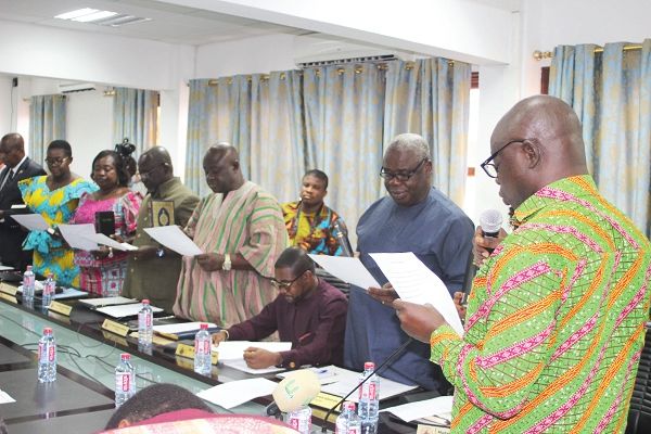  Mr Kwaku Asomah-Cheremeh (right), the Minister of Lands and Natural Resources, swearing the board members of the Minerals Development Fund into office in Accra. Picture: GABRIEL AHIABOR