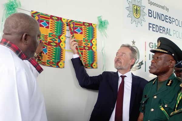 Mr Christoph Retzlaff (2nd right) and Mr Henry Quartey (left)  jointly unveiling the plaque to inaugurate the new office of the Document Fraud Detection Centre of the Ghana Immigration Service. Looking on is Mr Kwame Asuah Takyi (right), Comptroller General of the Ghana Immigration Service. Picture: GABRIEL AHIABOR