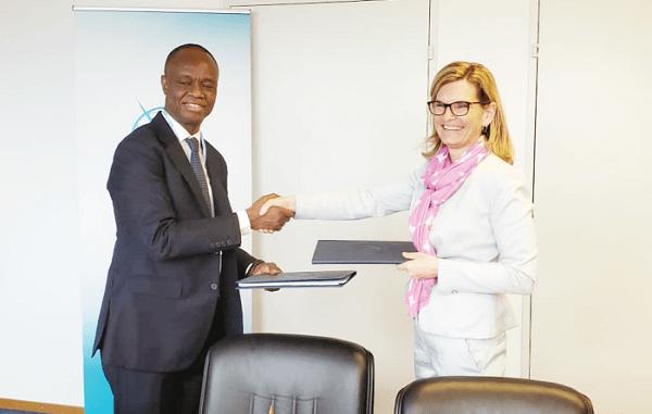 Mr Joe Anokye (left) and  Ms Doreen Bogdan-Martin exchanging documents after signing the licensing agreement