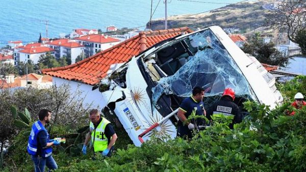 The bus plunged off a road and overturned near houses