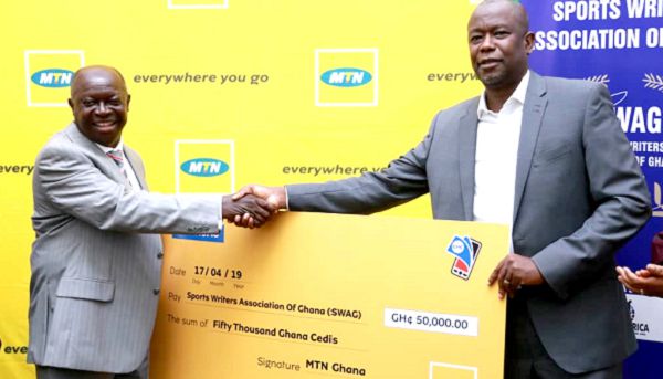 Mr Kwabena Yeboah (left) receiving the dummy cheque from Mr Samuel Koranteng of MTN at yesterday’s ceremony