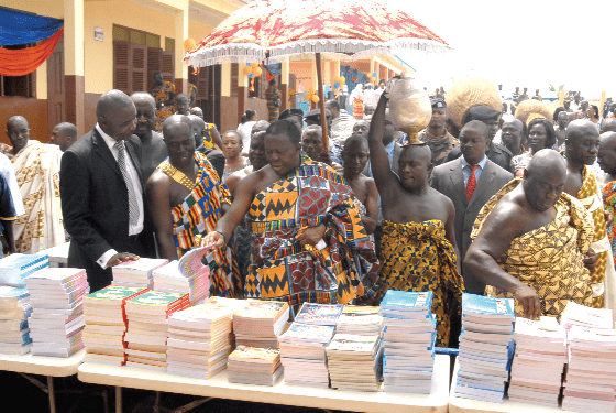 Otumfou Osei Tutu and other dignitaries go through some of the books donated to the schools