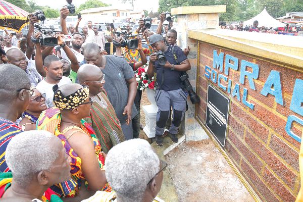 Dr Mahamudu Bawumia, the Vice-President and Daasebre Akuamoah Agyapong II, Kwahuhene admiring the plaque after it had been unveiled to inaugurate the centre. INSET: The front view of the Mpraeso Social Centre. Pictures: SAMUEL TEI ADANO