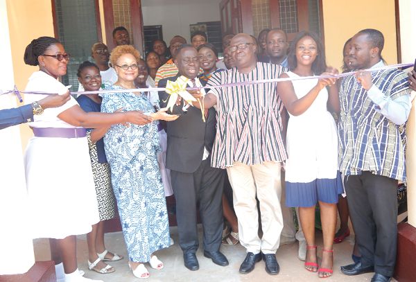 Dr Daniel Asare (3rd left) being assisted by Ms Angela L. Ofori Atta (2nd left), Mr Logosu Amegashie (3rd right) and other dignitaries to cut the tape to inaugurate the renovated centre. Picture: PATRICK DICKSON 