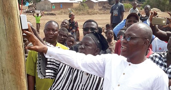Alhaji Issahaku Moomin (right) and Na Insah Seidu (in smock) switching on the power