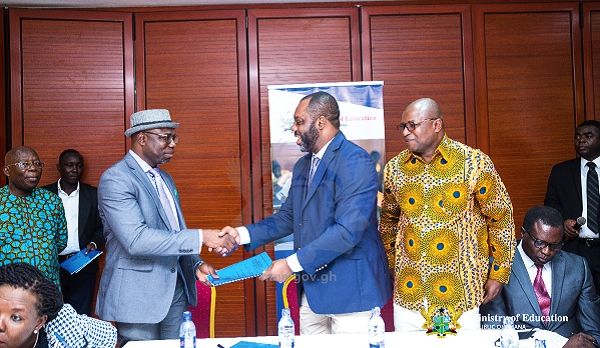 Dr Matthew Opoku Prempeh (middle) handing over a signed performance contract to Mr Christian Addai Poku, Executive Secretary of the National Teaching Council while Professor Eric Nyarko-Sampson, Council Chairman of the NTC looks on