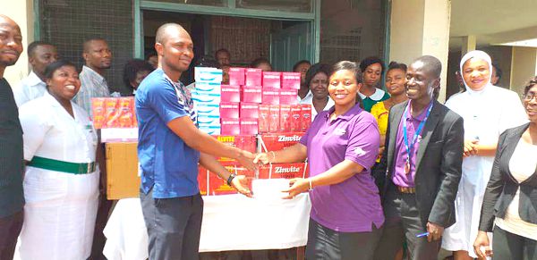  Ms Abigail Mireku presenting the medicines to the Health Service Administrator of the Ho Municipal Hospital, Mr Samuel Omega