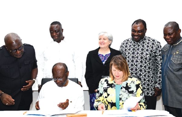 Mr Ken Ofori-Atta, (seated left) and Ms Bonnie Cybulko, Vice-President of the Industry Division of Exim Bank US glancing through the documents on the cooperation framework. Standing behind them as witnesses are from left: Mr Kwadwo Boateng Genfi, Board Chairman, GEXIM, Mr Lawrence Agyensem, CEO GEXIM, Mrs Stephannie Sanders Suliivan, Mr Robert Ahomka Lindsay, Deputy Minister of Trade and Mr Richard Osei Annane, Head of Corporate Affairs, GEXIM Bank Ghana. Picture: EBOW HANSON