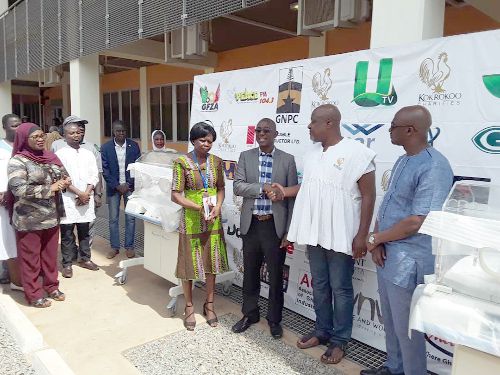  Mr Sefa Kayi (2nd right) in a handshake with Dr Kolbilla, the CEO of TTH when he handed over the incubators
