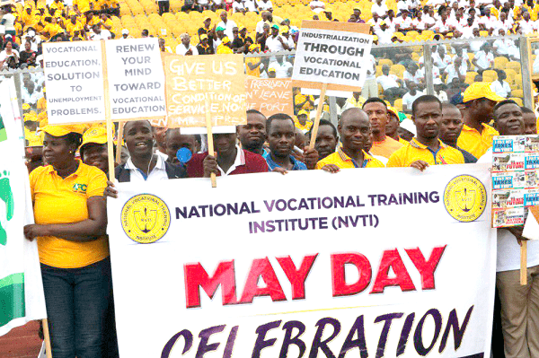 National Vocational Training Institute staff holding placards at last year’s May Day parade