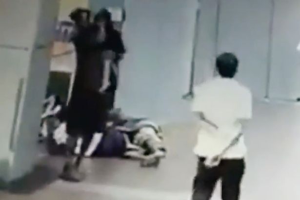 A man can be seen picking the little girl up and carrying her away from her sleeping mum