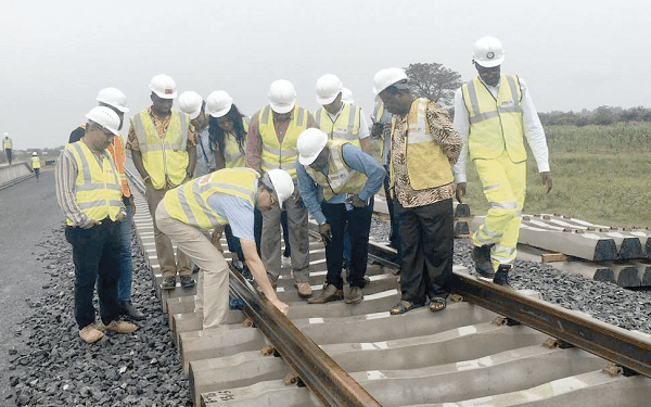 Mr Singh (4th right, in front)  explaining a point about the tracks to Mr Dombo (3rd right, in front) during the inspection 