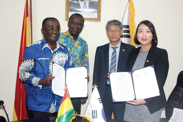 Dr Owusu Afriyie Akoto (left) and Ms Jeongyi Choi displaying the signed documents 
