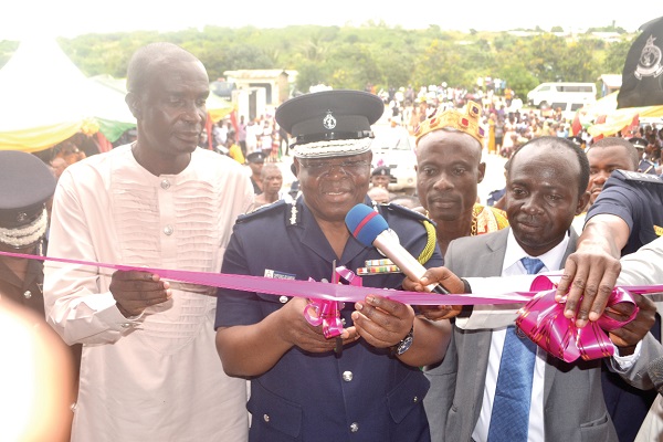 The acting IGP, Mr James Oppong-Boanuh (left) cutting the tape to inaugurate the new police station. Looking on is Mr Solomon Darko Quarm (right), the DCE for Gomoa East