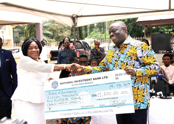  Dr Ibrahim Mohammed Awal (right), presenting a dummy cheque to Madam Grace Adusei, a beneficiary during the disbursement of the second tranche of funds for women entrepreneurs with disability. Picture: EDNA ADU-SERWAA