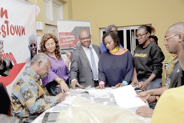 Mr Kojo Yankah (left), Founder and President of the African University College of Communication, autographing his book for the people who purchased it after the launch. Picture: EMMANUEL ASAMOAH ADDAI  