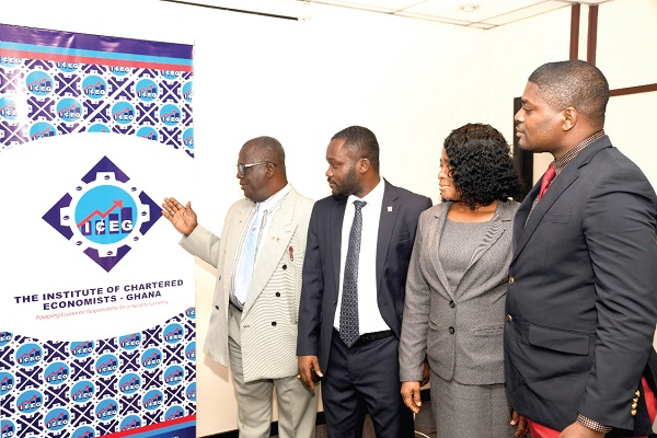  Prof Asubonteng (left) explaining the meaning of the new logo to some members of the Institute. Picture: EBOW HANSON
