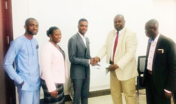 Prof. Owusu-Agyei (middle) presenting documents to Mr Ampofo-Domfeh, while Mr Joseph Acheampong (right), the Director of Projects of the company looks on 