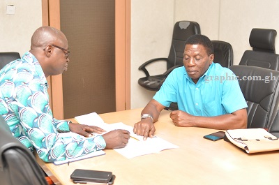 Mr Paul Avuyi (right) pointing out some clauses in the Police Service Regulations (CI 76) to our reporter, Mr Albert K. Salia. Picture: NII MARTEY M. BOTCHWAY