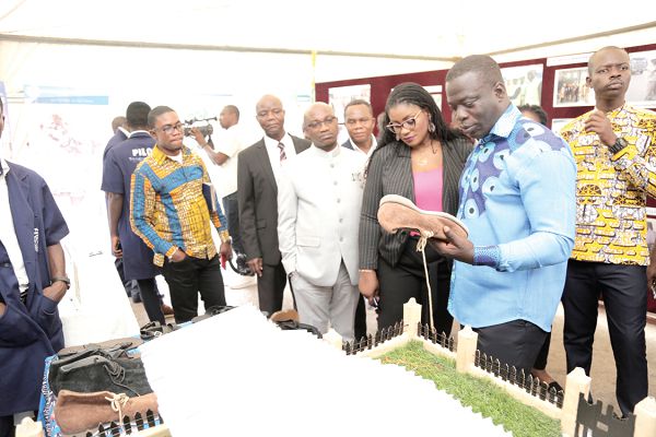 Mr Ignatius Baffour Awuah (right) admiring some of the products from agencies under his ministry during an exhibition mounted as part of the Meet-the-Press series. Those with him are Ms Nana Ama Dokuaa Asiamah Agyei (2nd right), a Deputy Minister of Information, and Mr Bright Wireku-Brobbey (3rd left), a Deputy Minister of Employment and Labour Relations. Picture: EMMANUEL ASAMOAH ADDAI