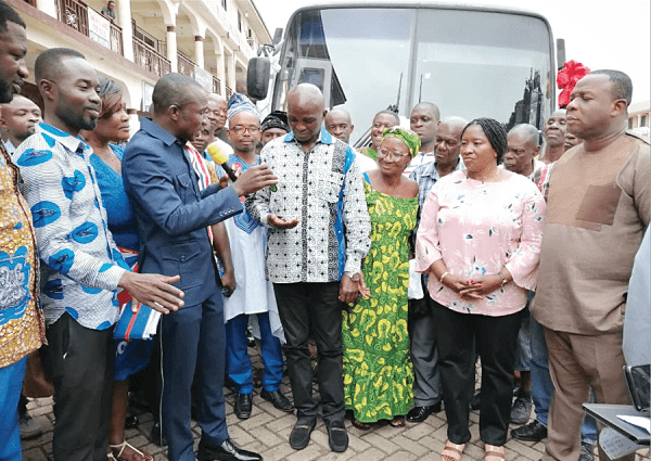 Mr Kennedy Kwasi Kankam (2nd left) presenting the keys to the bus to the Chairman, Mr George Agyei. On the far right is Mr Lord Commey