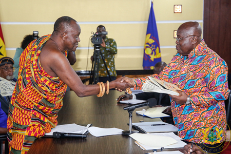 President Nana Addo Dankwa Akufo-Addo receiving documents from Nana Otuo Sriboe, Chairman of the Council of State at the Jubilee House in Accra
