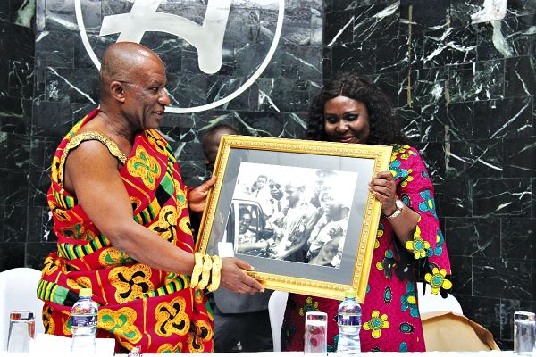 Maame Yaa Edusei (right), presenting to Nana Akyena Kwagyan Nuama V, a framed picture of the late B.K. Edusei, being handed the African Cup from the then Kotoko captain, Ibrahim Sunday back in 1971.