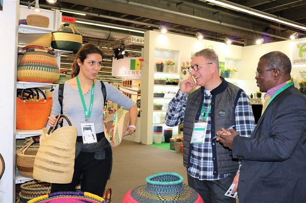 Rev Mawuli Akpenyo (right) CEO of Delata explaining some points to some clients at his stand at the fair.