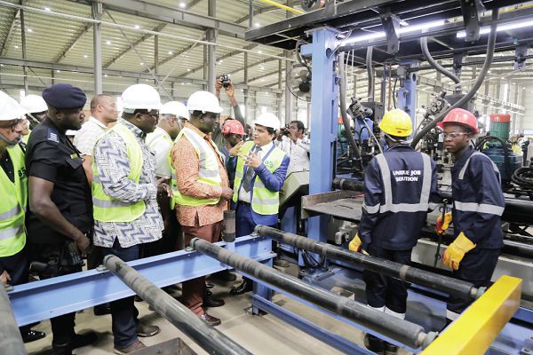 Mr Mukesh Thakwani (right), Chief Executive Officer (CEO), B5 Plus Limited, explaining the process of steel manufacturing to Mr Alan Kyerematen (2nd right), Minister of Trade and Industry, and Mr Robert Ahomka-Lindsey, a Deputy Minister of Trade and Industry, during the tour of the factory